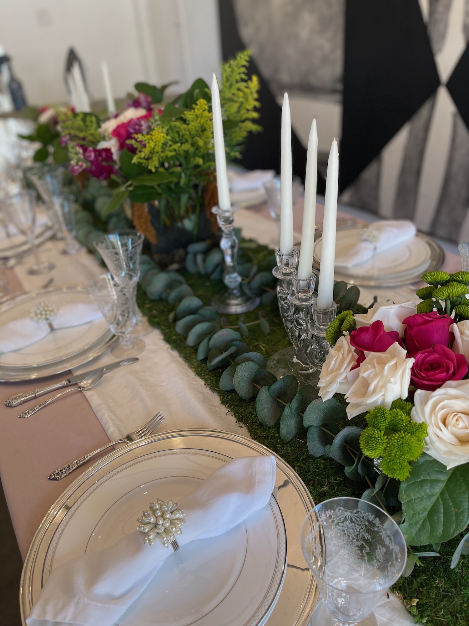 Tablescape with moss runner, crystal candelabra and roses