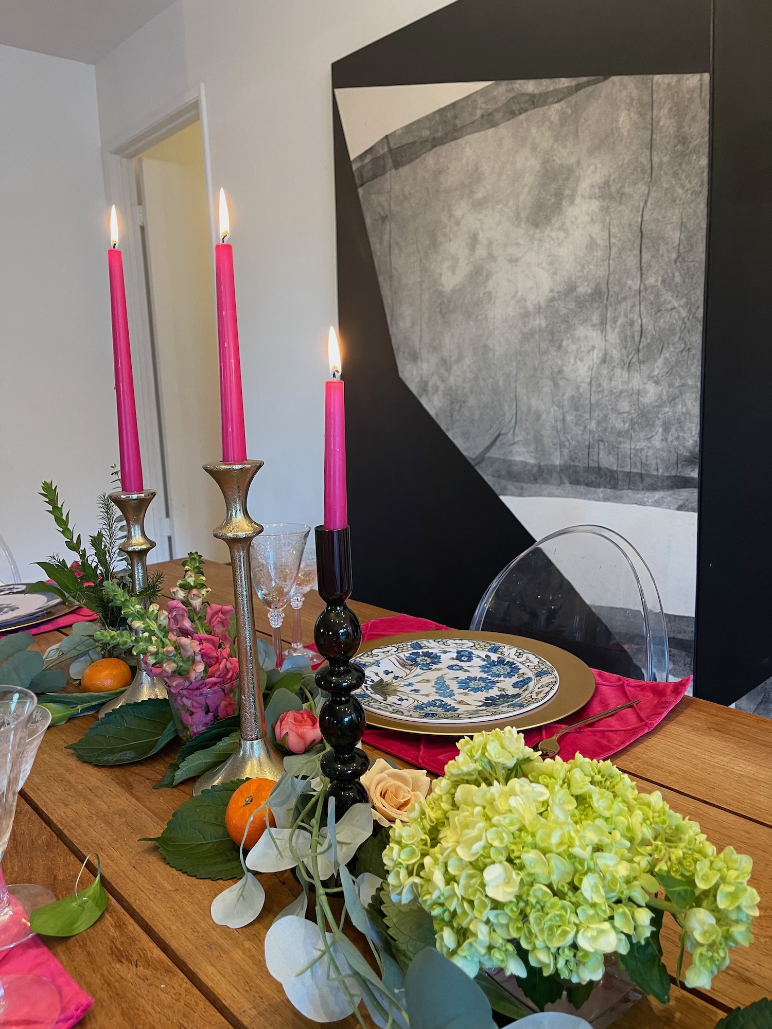 Table vignette with pink tapers, hydrangea and graphic black-and-white backdrop